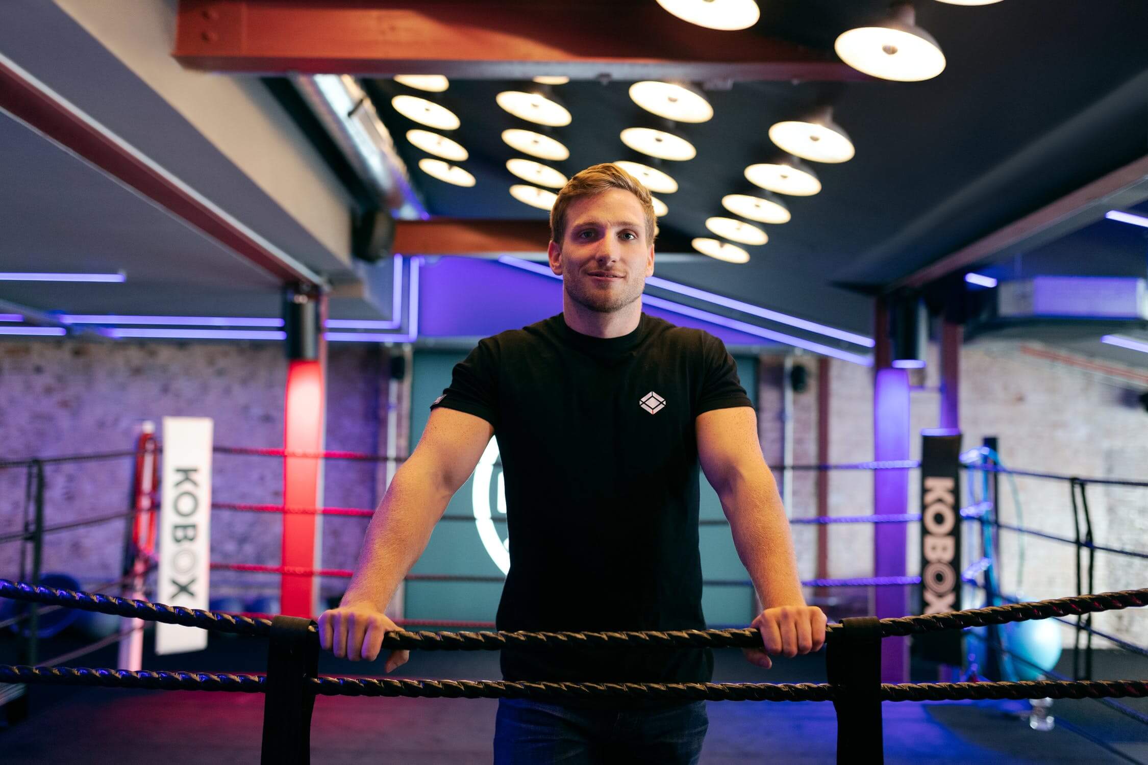 picture of Harry Colllins with arms crossed in a boxing ring